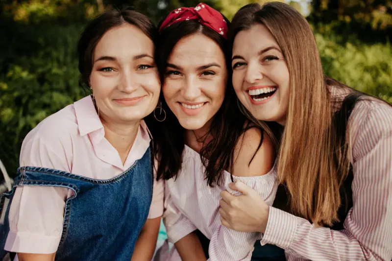 chronic-pelvic-pain-montmorency-social-confidence Three women laughing together outdoors, illustrating the social confidence and physical autonomy supported by evidence-based management of chronic pelvic pain in Montmorency at Monty Pelvic Physio.