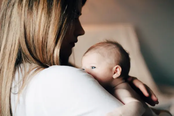 A mother holding her newborn close, representing the collaborative clinical management and obstetrician correspondence provided at Monty Pelvic Physio for families in Eltham and Montmorency.